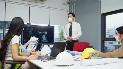 Group of Asian team business people working in office with new normal social distancing lifestyle.