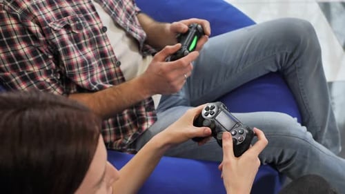 Woman and Man Play Video Games Indoors