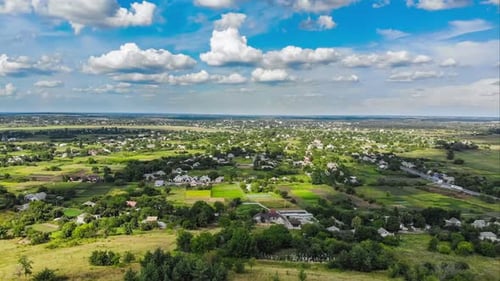Hyperlapse of Village and Small Houses with Moving Clouds in Sky From a Flying Drone