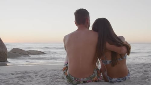 Loving Couple Enjoying Sunrise on the Beach