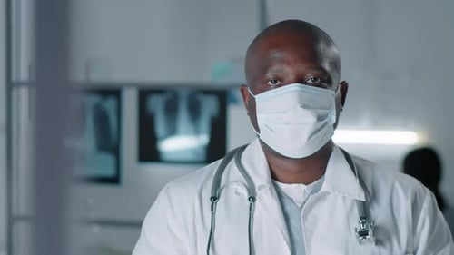 Doctor in Mask with Stethoscope in Hospital