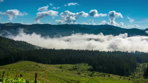Mountain Range with Clouds and Forested Landscape