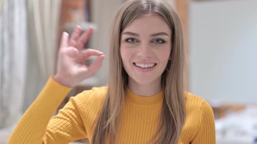 Young Woman Giving Ok Gesture