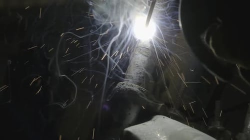 Close-up hand of Metal welder working with an arc welding machine.