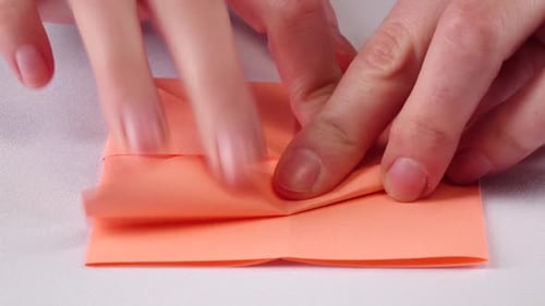Hands Making Origami. White. Close Up. Time Lapse