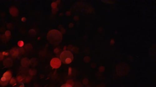 Abstract Red Bokeh Orbs Floating in Space