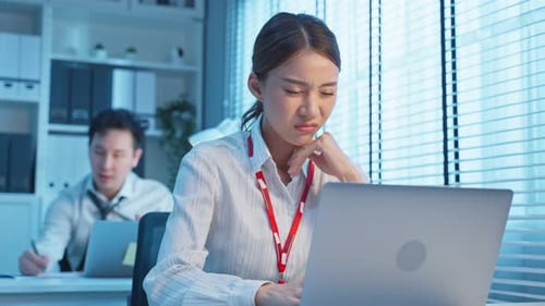 Exhausted Asian busy Employee people feel tired and headache from late of work at night in office.