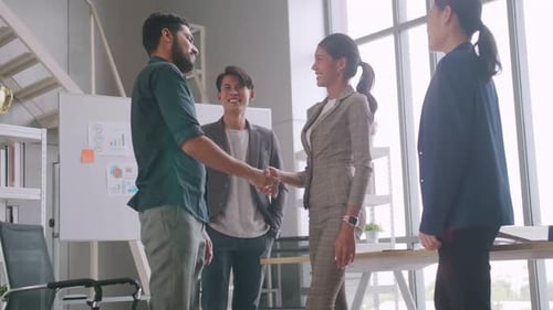 Business People Discuss Ideas and Shake Hands in Office