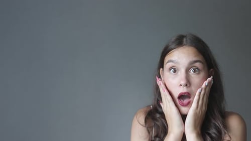 Surprised Emotions on Caucasian Young Female Portrait Face Gray Background Wow