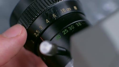 Adjusting Focus on Vintage Camera Lens Close Up