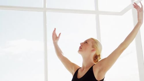 Blonde Woman Stretching in Dance Studio