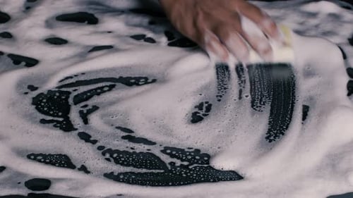 Sponge Wiping Soapy Surface for Cleaning Purposes