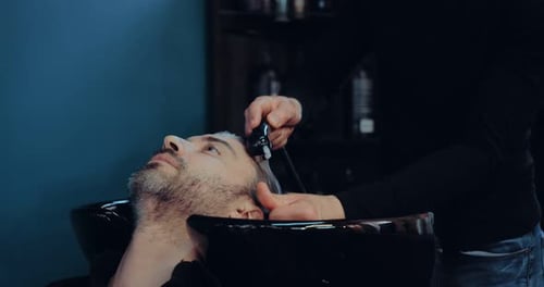Barber Washing Hair in Salon with Gentle Massage