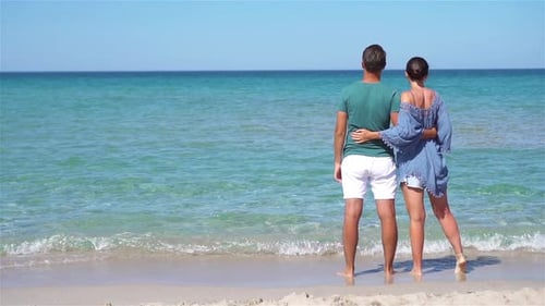 Young Couple on White Beach During Summer Vacation.