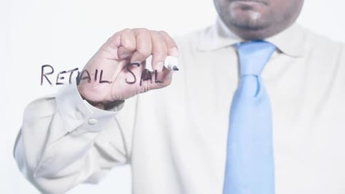 Asian Businessman Writes Retail Sales