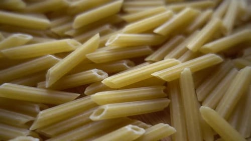 Golden Penne Pasta Filling the Frame Close Up