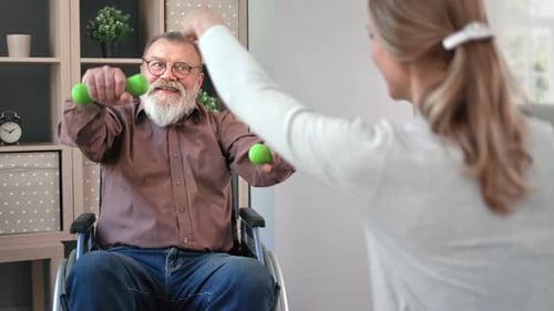 Senior Man Exercising with Dumbbells in Wheelchair