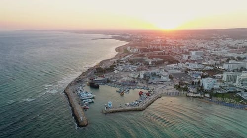Aerial View of Pier in Summer Seaside City - Cinematic shot during Sunset