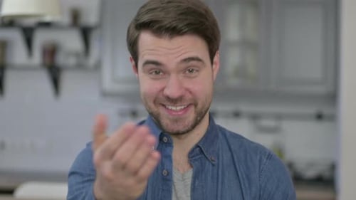 Portrait of Beard Young Man Pointing Finger and Inviting