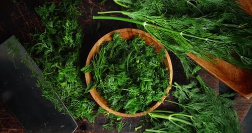 Fresh Chopped Dill on a Dark Wood Table