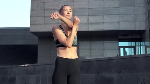 Young Adult Woman Stretching Before Workout