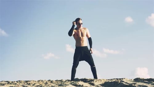 Young Man Dancing on Sand Dune Barefoot