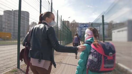 Woman and Girl Walking to School
