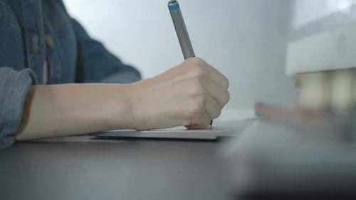Hand Using Stylus on Graphic Tablet