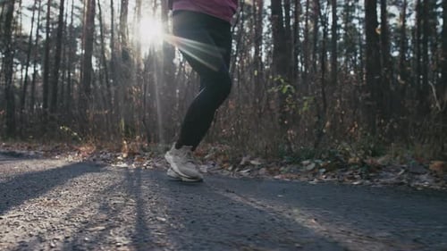 Slow Motion Video Closeup of Legs Running on a Park Path