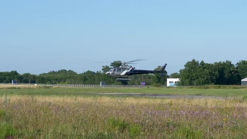 Helicopter hovering and then taking off from a Helipad on a sunny day