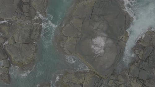 Waves Crash Against Rocks in the Ocean