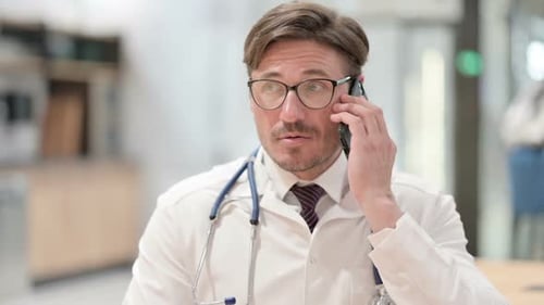 Doctor Using Phone in Hospital Making Call