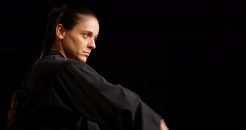 Woman in Black Uniform Practicing Martial Arts Punch