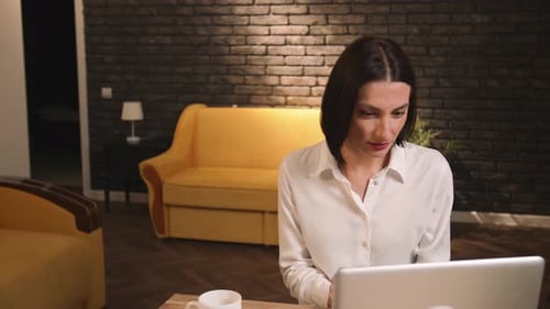 Excited Businesswoman Winner Looks at Laptop Celebrates Online Success Sits at Home or Office