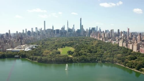 Beautiful Central Park View with Lake and Manhattan Skyline in Background at Sunny Summer