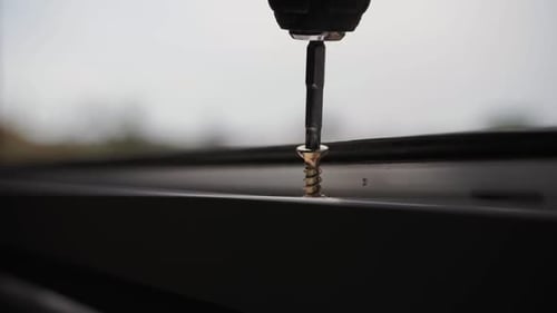 Drill Driving Screw Into Surface Close Up