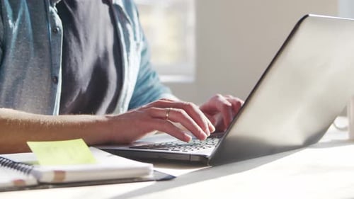 Young male entrepreneur works at home office at the computer.