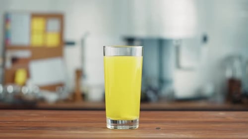 Effervescent Tablet Dissolving in a Glass of Yellow Drink