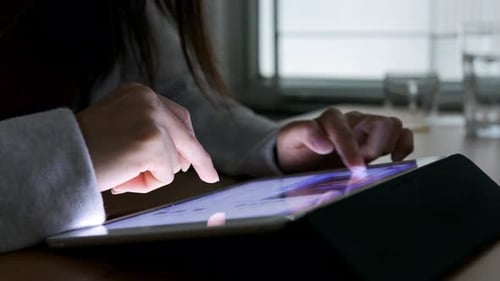 Woman using tablet computer at home
