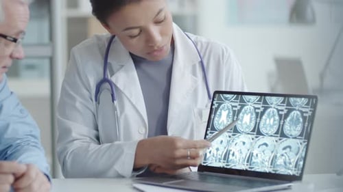 Doctor Explains Brain Scan Results to Patient