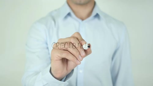 Writing the Word Credibility on Clear Surface