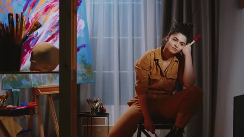 Thoughtful Woman Artist Posing in Art Studio