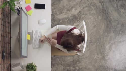 Top view of smiling Asian business woman, person working from home, typing on a keyboard