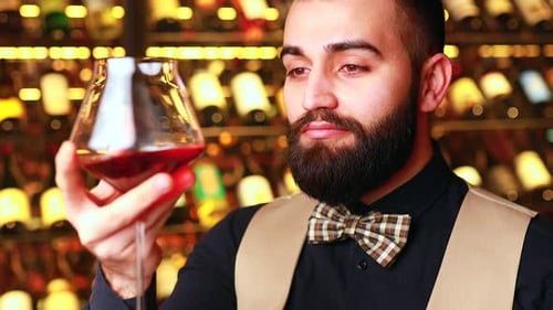 Young Adult Smelling Red Wine Close Up