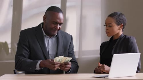 Adult Mature African Man Counts Money Shares Profits Finances Gives Dollars Salary Afro Woman