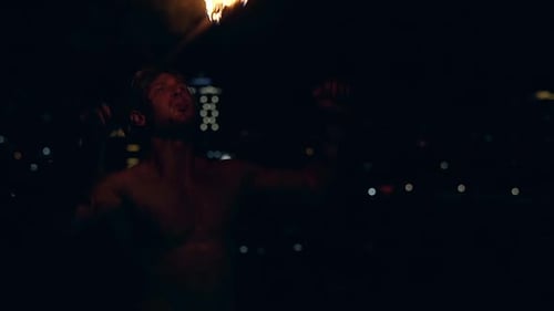 Young Blond Male Breathes Out Large Stream of Fire Multiple Times Making Fireballs Slow Motion