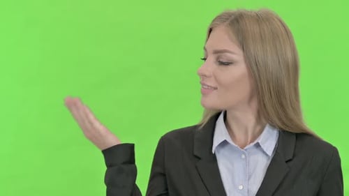 Empresaria alegre que muestra la palma de la mano abierta contra la clave de croma