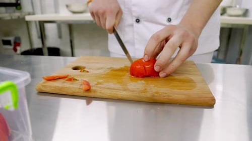 Chef Precisely Slicing Fresh Red Tomatoes