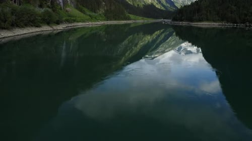 Aerial Reveal Faatage Starting with Lake and Ending with Mountain