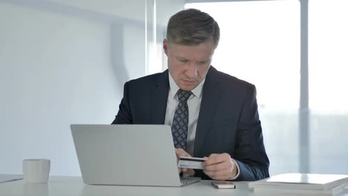 Successful Online Shopping with Credit Card on Laptop